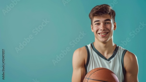 A young athlete showcases his enthusiasm for basketball while holding a ball photo