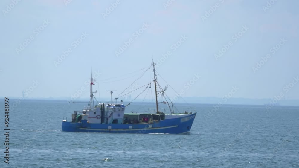 Fishing boat sailing on the open sea under clear skies in 4k