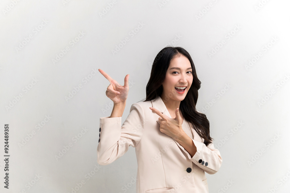 Beautiful young Asian woman pointing up to copy space and looking at camera with smile face and happy Pretty girl act like a satisfied product, use for advertising with isolated on white background Beautiful young Asian woman pointing up to copy space and looking at camera with smile face and happy Pretty girl act like a satisfied product, use for advertising with isolated on white background