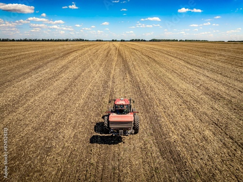 Fotografie tractor with fertilizer spreader on field