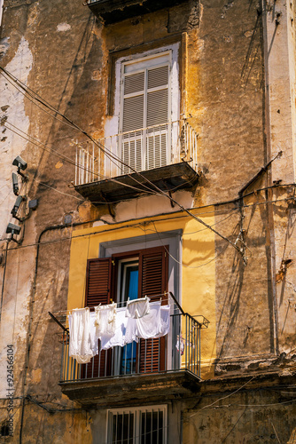 Obraz na płótnie Rustic Urban Balcony with Laundry Hanging to Dry, typical facade view in Naples, Italy w salonie