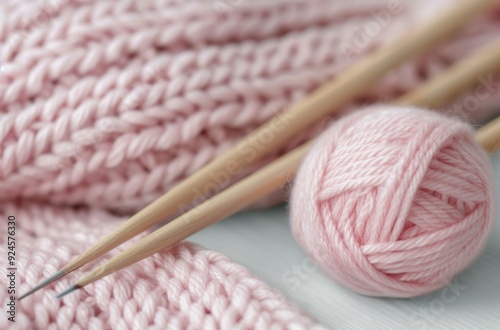 Pink Yarn Ball and Knitting Needles With Soft Knit Fabric