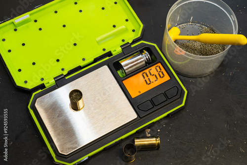 Reloading 45 acp pistol caliber cartridges, scales for weighing gunpowder, cartridges. photo