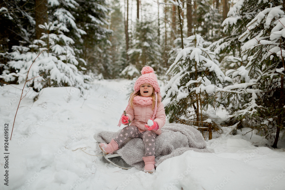 Fototapeta premium little child playing with snow in the park