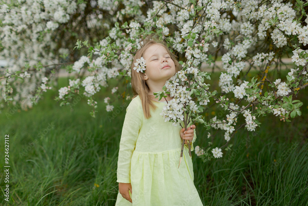 little girl in the spring field with flowering tree little girl in the spring field with flowering tree