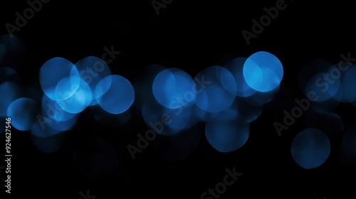 Ethereal Blue Orbs in Bokeh Against a Black Background