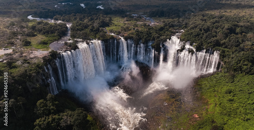 Kalandula Waterfall cascading through lush greenery in Angola during daylight photo