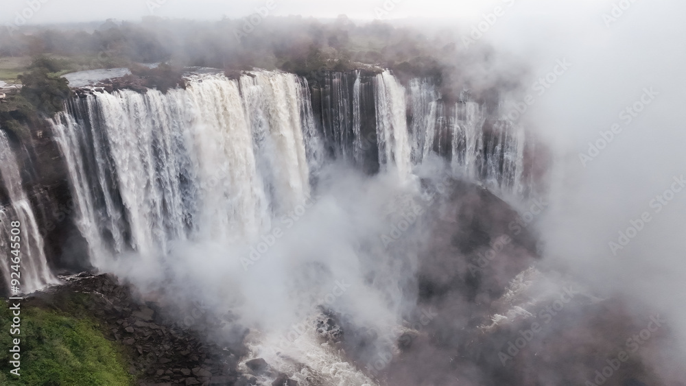 Kalandula Waterfall cascading majestically in Angola with mist enveloping the surroundings Kalandula Waterfall cascading majestically in Angola with mist enveloping the surroundings
