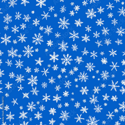 This seamless pattern showcases white snowflakes on a vibrant blue background, creating a wintry and festive mood, perfect for seasonal projects or holiday-themed designs.