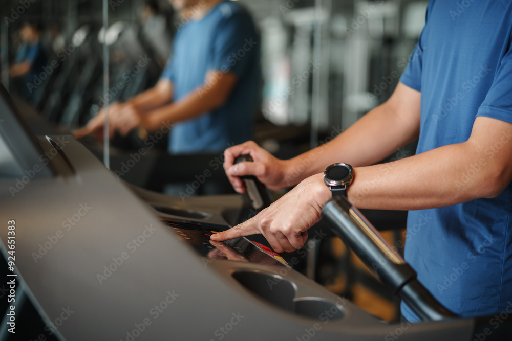finger pushing start button on treadmill at fitness gym exercise finger pushing start button on treadmill at fitness gym exercise