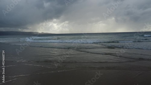 Aerial view of sandy beach and ocean with waves