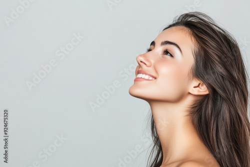 Isolated on a transparent background, this portrait shows a beautiful woman with a smile and looking upwards