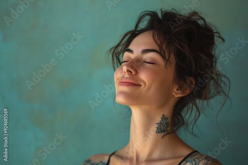 A close up of a woman's face with tattoos and her eyes closed