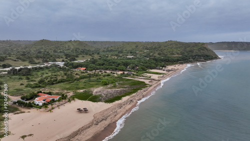 Aerial view of the lush green coast of Angola showcasing the shoreline and surrounding hills