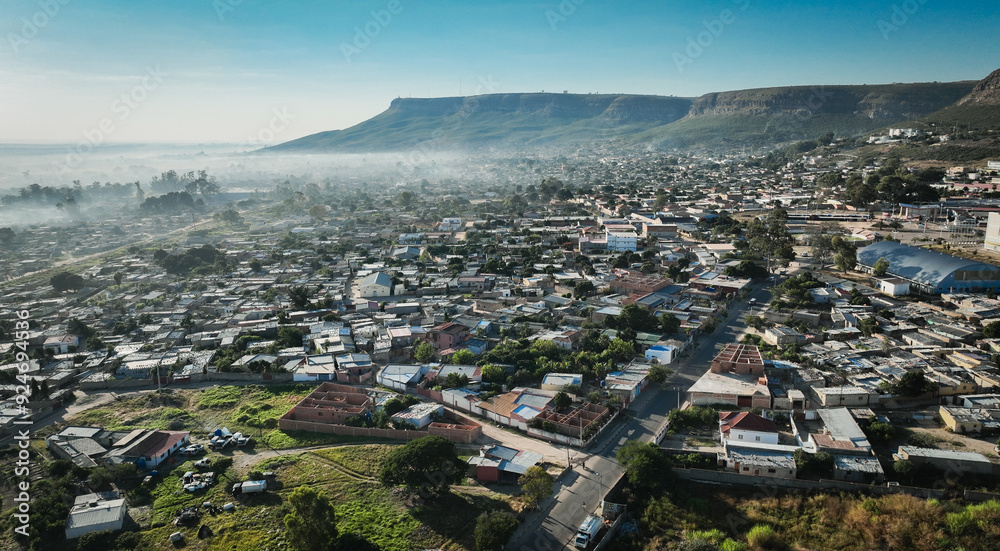 Fototapeta premium Aerial view of Lubango City showcasing urban layout and surrounding landscape in Angola during early morning