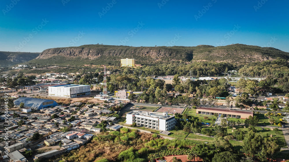 Obraz premium Aerial view of Lubango City showcasing urban scenery and mountainous backdrop in Angola
