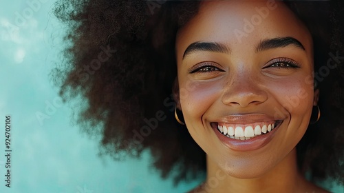 Woman smiling confidently, showcasing her healthy hair, with a clear area for copy space