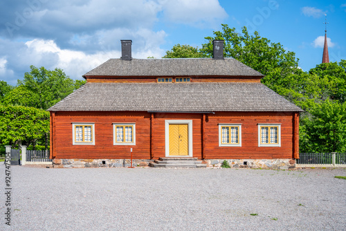 A traditional Swedish wooden house at Skogaholm Manor, displaying Sweden historical architecture on a bright sunny day. Stockholm, Sweden photo