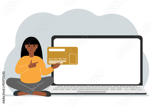 A woman sits cross-legged and holds a large plastic card. Next to the woman is a large laptop with space for text.