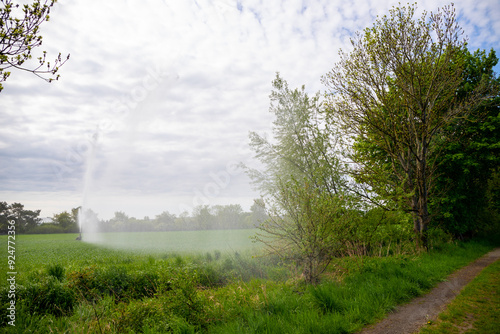 Field with hill and a water cannon irrigating