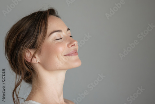 A close up of a woman's face with tattoos and her eyes closed