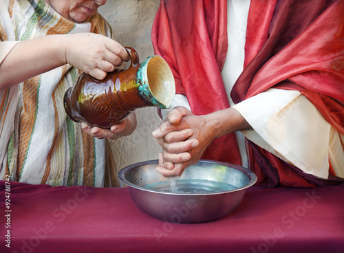 The servant pours water, and the master washes his hands