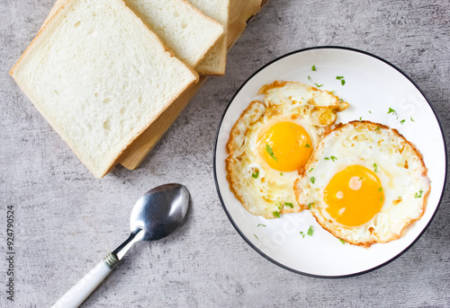 a plate of fried eggs and bread as a breakfast menu