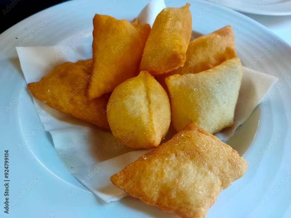 Golden Crispy Gnocco Fritto: Traditional Italian Fried Dough Appetizer on White Plate Golden Crispy Gnocco Fritto: Traditional Italian Fried Dough Appetizer on White Plate