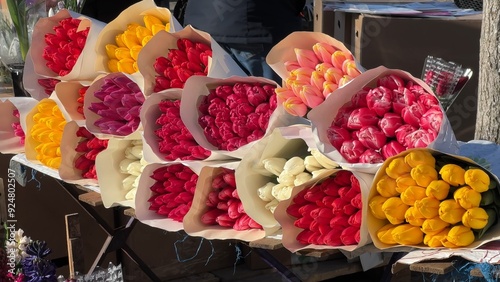 Selling bouquets of tulips on the city street. photo