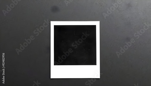 Black polaroid photo set against a gradient grey background transitioning from dark to light