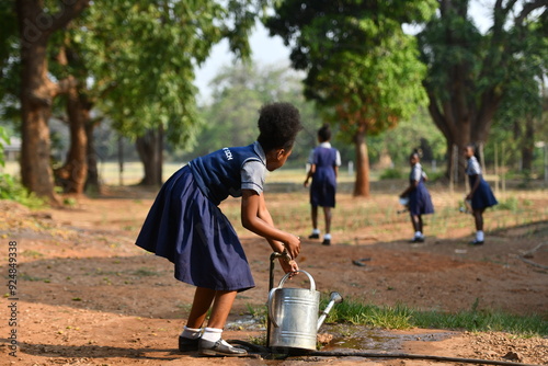 Schoolgirl with watering can
