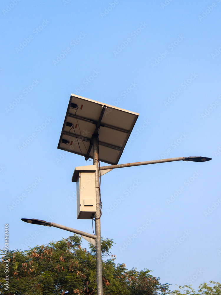A minimalist image of a solar-powered street lamp set against a clear blue sky, highlighting sustainable energy solutions in urban infrastructure. Ideal for renewable energy and technology themes