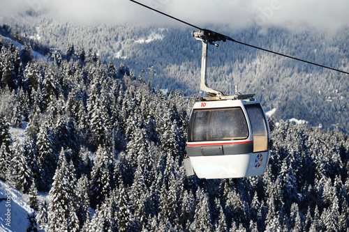 Vintage ski gondolas over Courchevel ski resort by winter