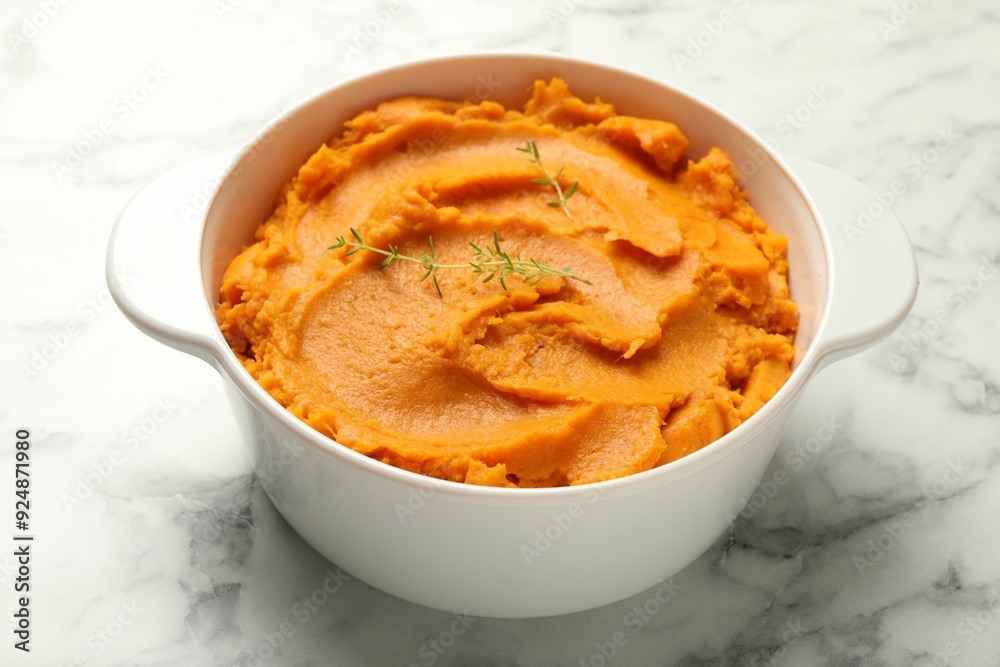 Delicious mashed sweet potatoes in pot on white marble table, closeup Delicious mashed sweet potatoes in pot on white marble table, closeup