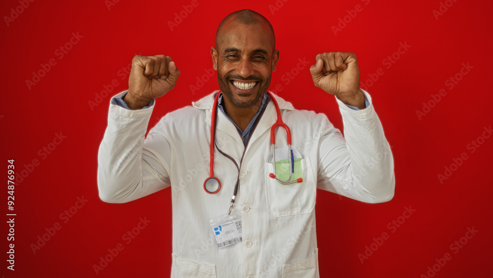 Handsome doctor man over isolated red background smiling joyfully with clenched fists, celebrating success wearing a white coat and stethoscope Handsome doctor man over isolated red background smiling joyfully with clenched fists, celebrating success wearing a white coat and stethoscope