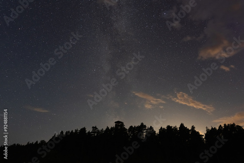 Estonia nature, night scene, milky way and stars over forest and Pikanomme observation tower. photo