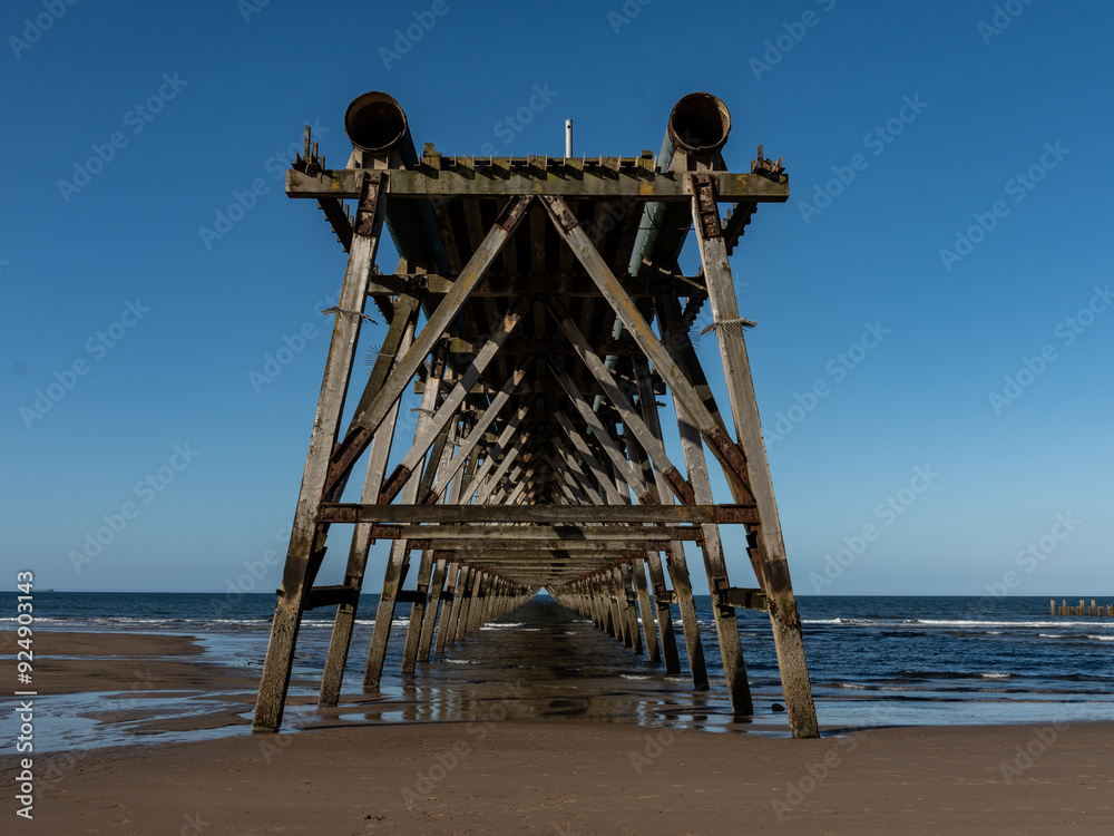 Old wooden pier structure stretching into the sea Old wooden pier structure stretching into the sea