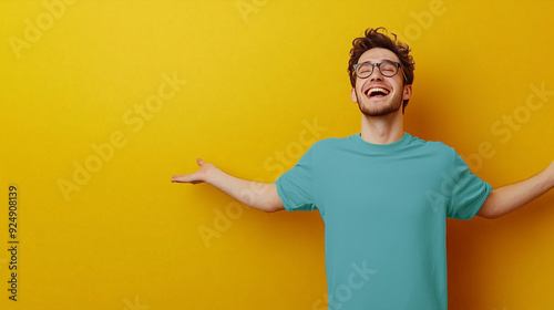 Portrait of a happy young man, isolated on a yellow background. Expressive and enthusiastic, with room on the side for a news title or sales post.