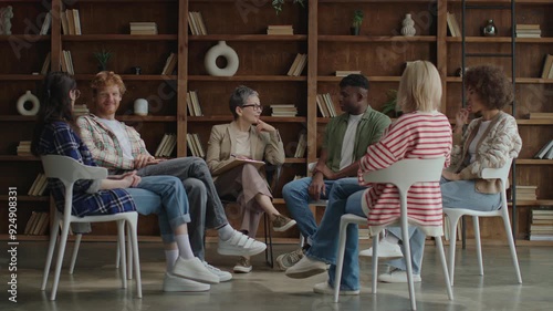 A diverse therapy group session radiates a positive mood, showcasing members connecting and engaging in a supportive environment filled with optimism and encouragement