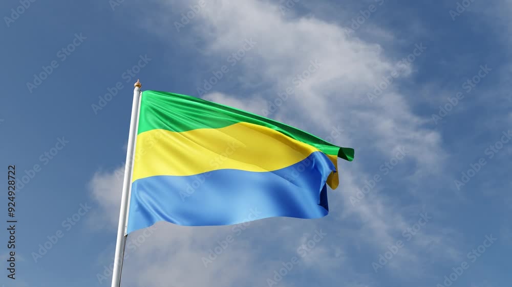 Flag of gabon on a blue sky, flag on a flag pole waving in the wind, african country, national symbol of gabon, video of a flag Flag of gabon on a blue sky, flag on a flag pole waving in the wind, african country, national symbol of gabon, video of a flag