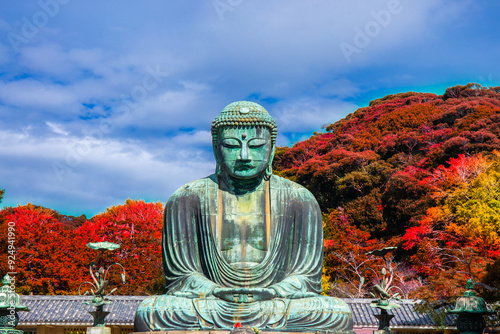 Daibutsu or Great Buddha of Kamakura in Kotokuin Temple at Kanagawa Prefecture Japan with leaves changing color It is an important landmark and a popular destination for tourists and pilgrims.
