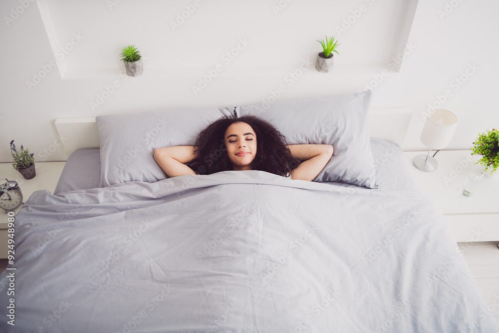 Photo of charming young woman lying bed hands behind head have rest good morning vibes awake home bedroom light white interior Photo of charming young woman lying bed hands behind head have rest good morning vibes awake home bedroom light white interior