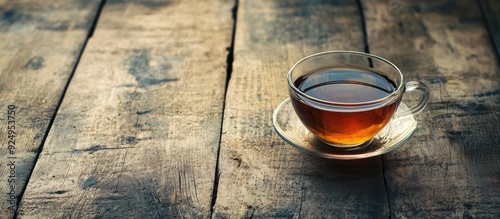 Glass cup of tea on aged wo...