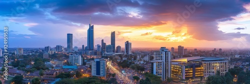 Breathtaking Sunset Over Modern Cityscape - A vibrant cityscape at sunset, showcasing modern skyscrapers against a backdrop of clouds, symbolizing urban development, growth, ambition, and the beauty o