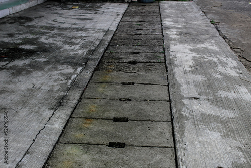 Selective focus of a gutter cover on the side of the road during the day