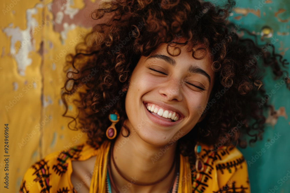 Sunset Joy: Smiling Woman with Curly Hair Against Colorful Wall Sunset Joy: Smiling Woman with Curly Hair Against Colorful Wall