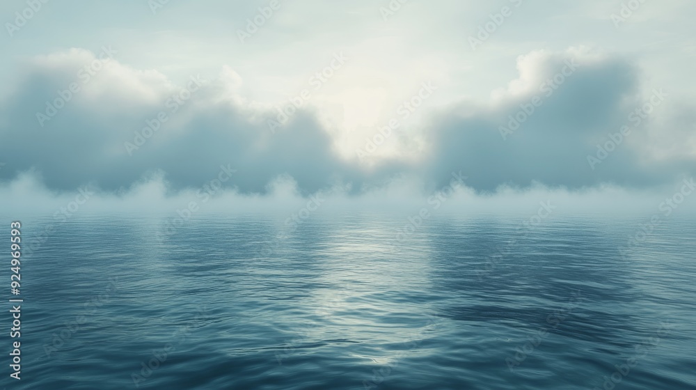 Obraz premium A tranquil scene of a vast body of water with a misty horizon and soft, ethereal clouds. The water reflects the soft light of the sky.