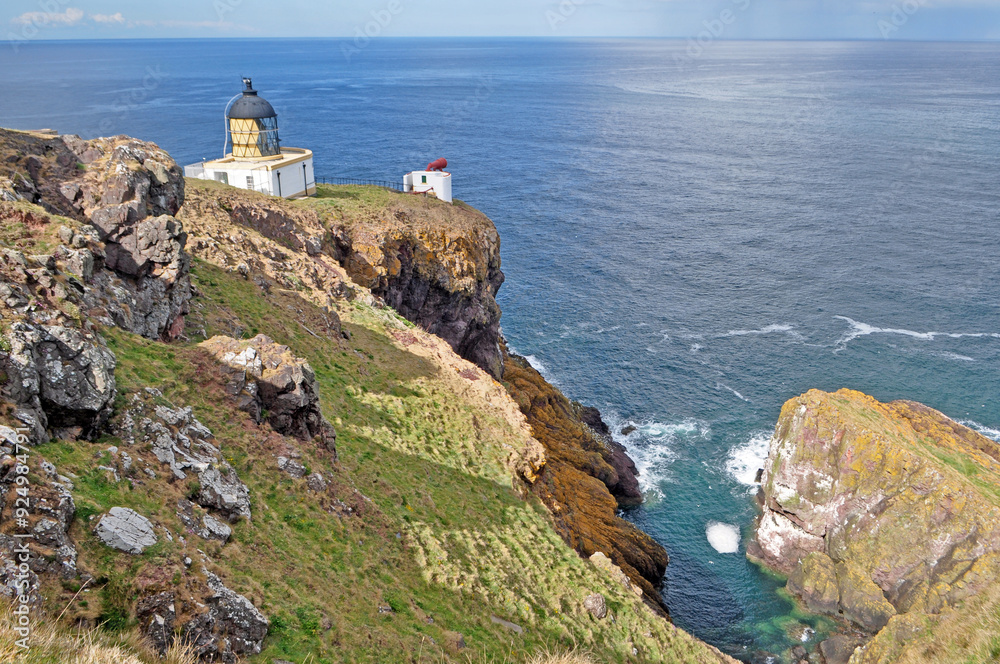 Lighthouse on top of the cliff in Scotland Lighthouse on top of the cliff in Scotland