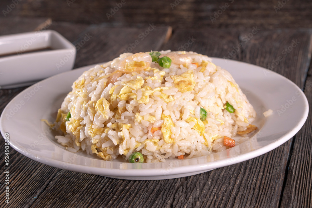 rice with omelet and shrimp on a plate on a wooden background rice with omelet and shrimp on a plate on a wooden background