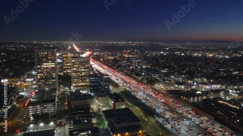 Wallpaper Mural Aerial view of a busy nighttime traffic jam in Los Angeles downtown area, illuminated by city lights as cars line the highway, showcasing the metropolitan landscape and urban congestion Torontodigital.ca
